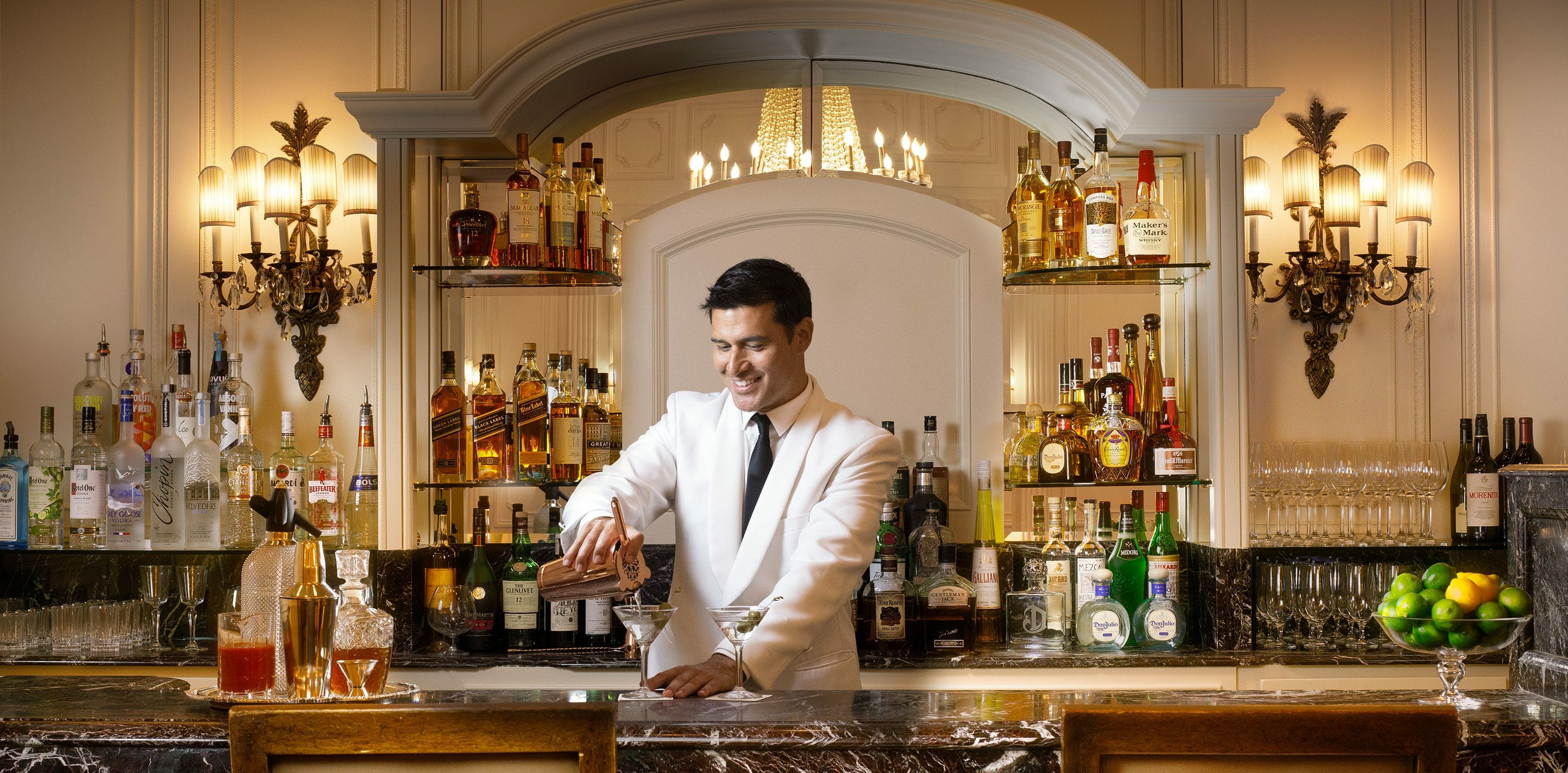 Bartender making a drink behind the counter of the Westgate Hotel Plaza Bar