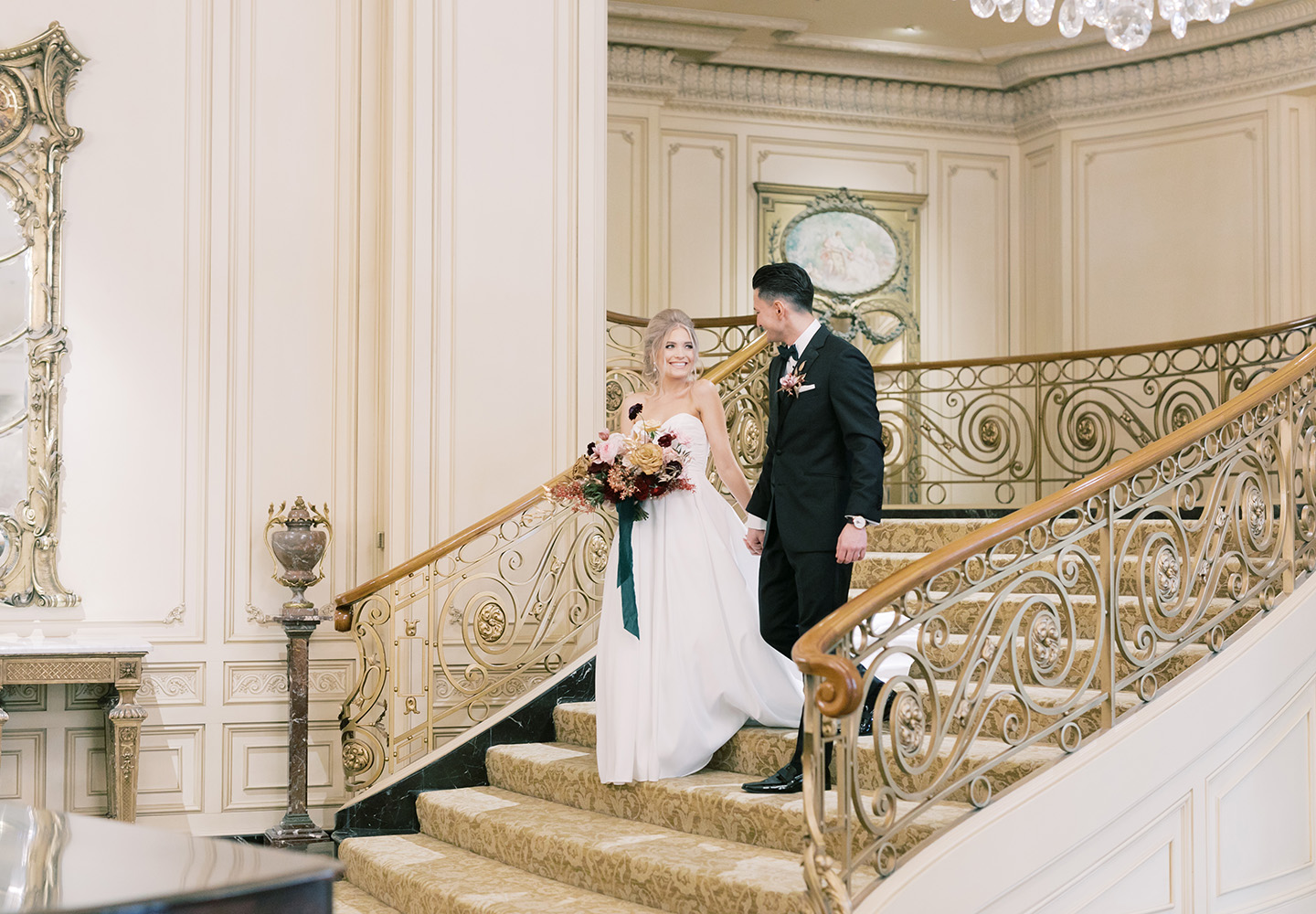Newwlyweds on grand staircase at The Westgate Hotel