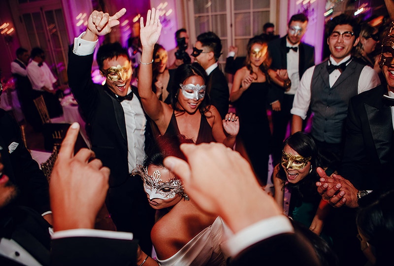 People dancing in masks in Versailles Ballroom at The Westgate Hotel