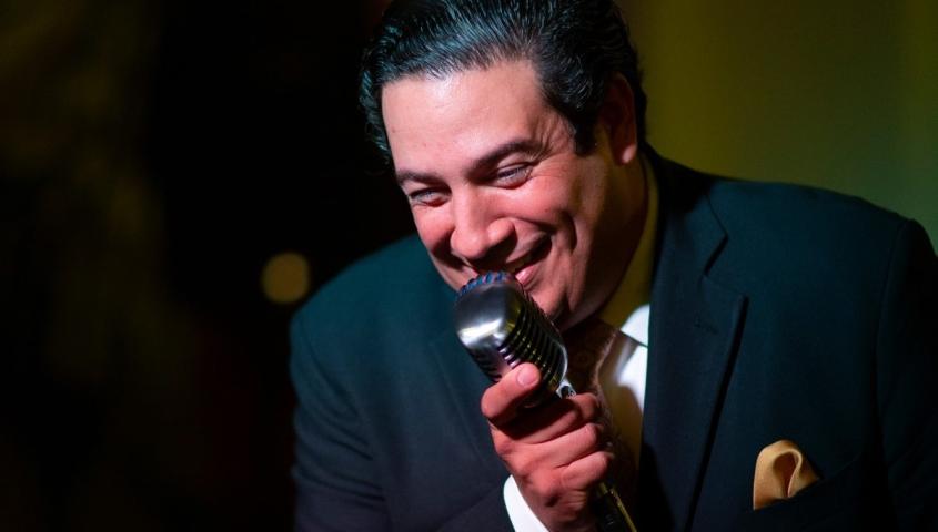 roman palacios Roman Palacios singing with a microphone